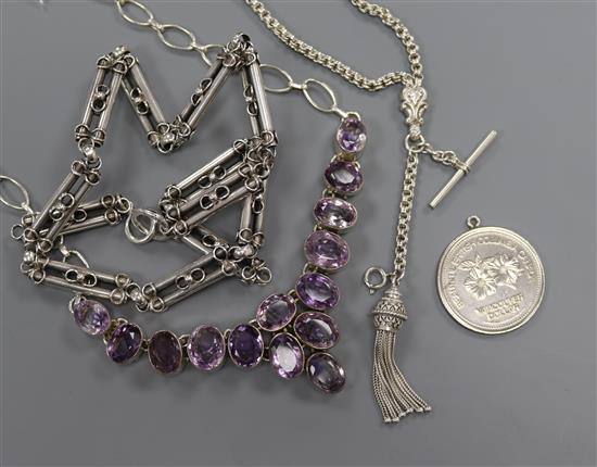 A white metal and amethyst necklace, a white metal fob, a Vancouver dollar and an Edwardian style white metal necklace.